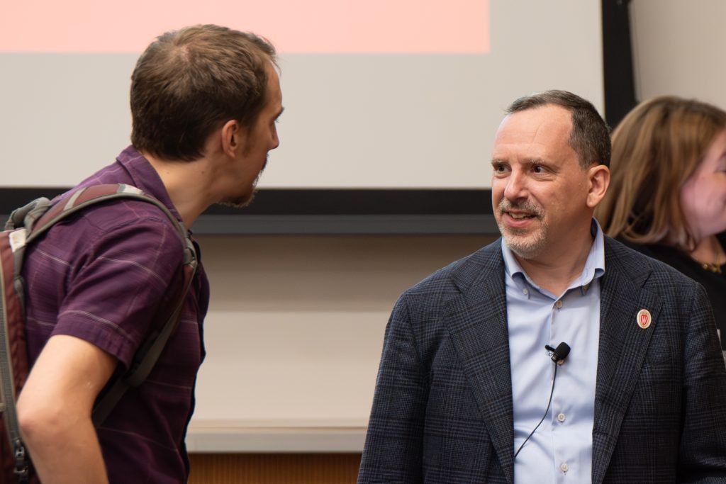 Didier Contis converses with an attendee.