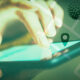 Person using smartphone with virus superimposed over