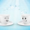 Two cups of coffee talking about IT.
