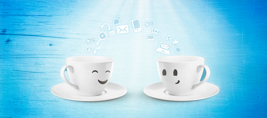 Two cups of coffee talking about IT.