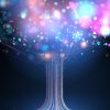 Glowing tree of digital light and multicolored shimmering bokeh particles.