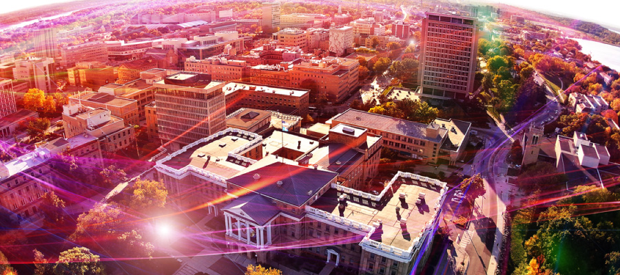 Aerial photo above Bascom Hill with various colored light streaks representing data and speed
