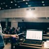 Person presenting at a podium in front of an audience