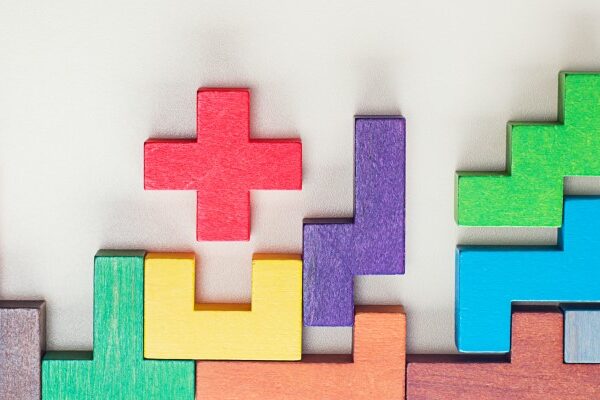 Tetris shaped building blocks falling into place