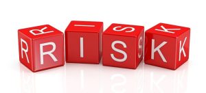 Four red dice spelling out the word 'RISK' in white letters