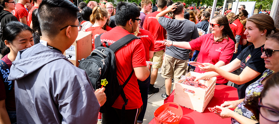 People at booth giving away Badger swag items