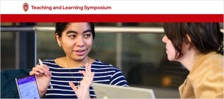 A person is explaining something to another person while using laptop computers.