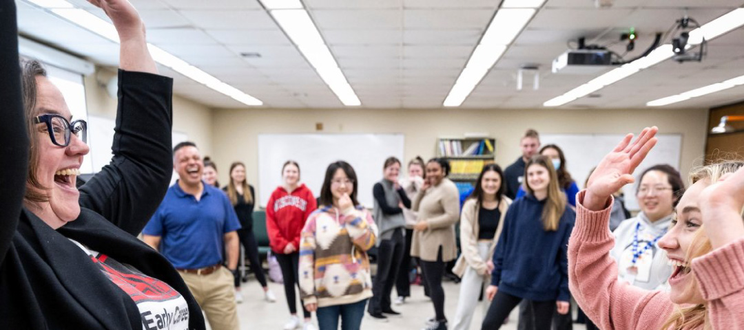 Guest lecturer Lisa Barker (left) leads an improvisational exercise with a student in a Curriculum & Instruction class.