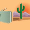 A laptop and suitcase against a desert landscape