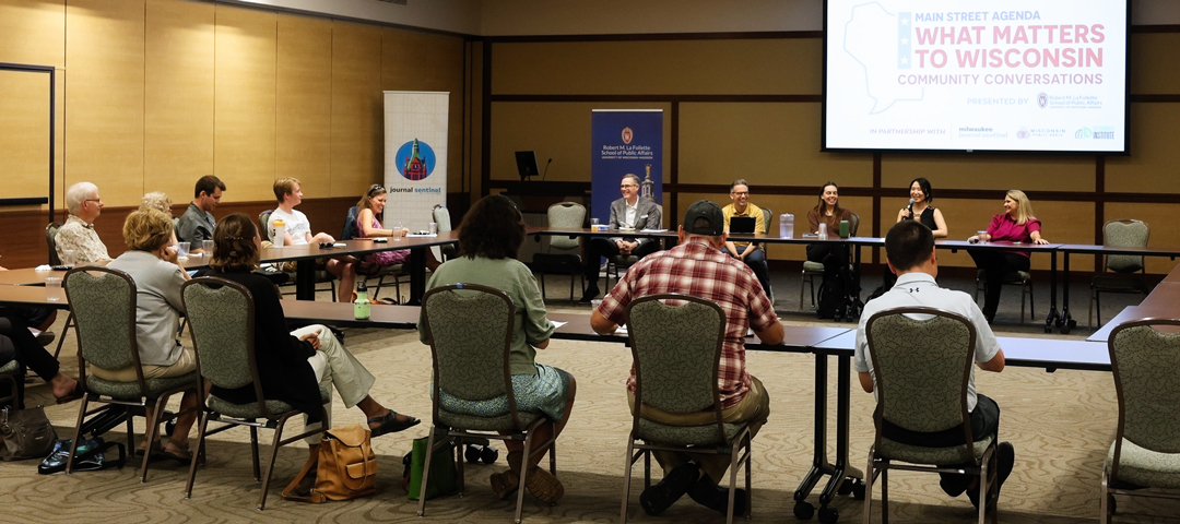 A group meeting with a projected slide that reads, "What matters to Wisconsin".